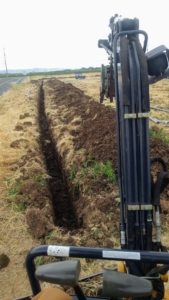 view of a large trench from within an excavator