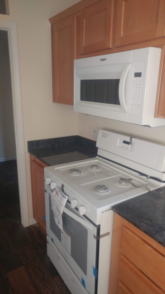 a Kitchen with tan walls and pine cabinets