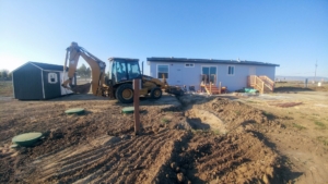 a backhoe moving dirt to settle it