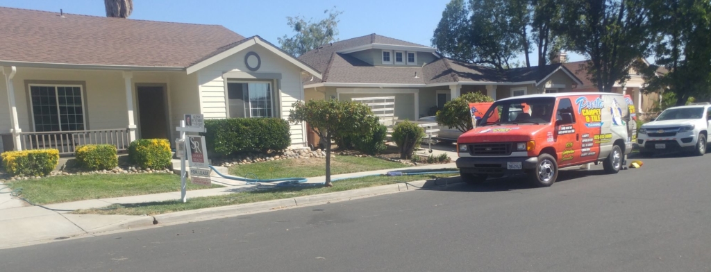 Carpet cleaner in front of a house