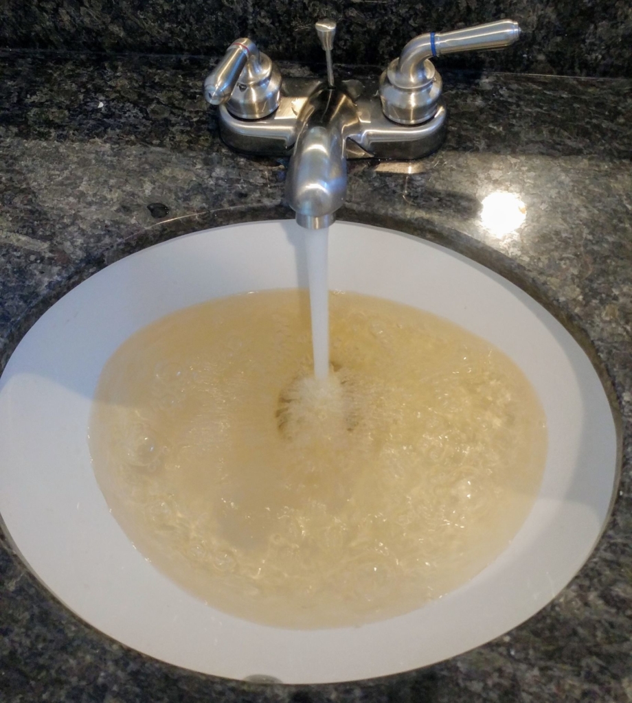 sink filling with dirty yellow water