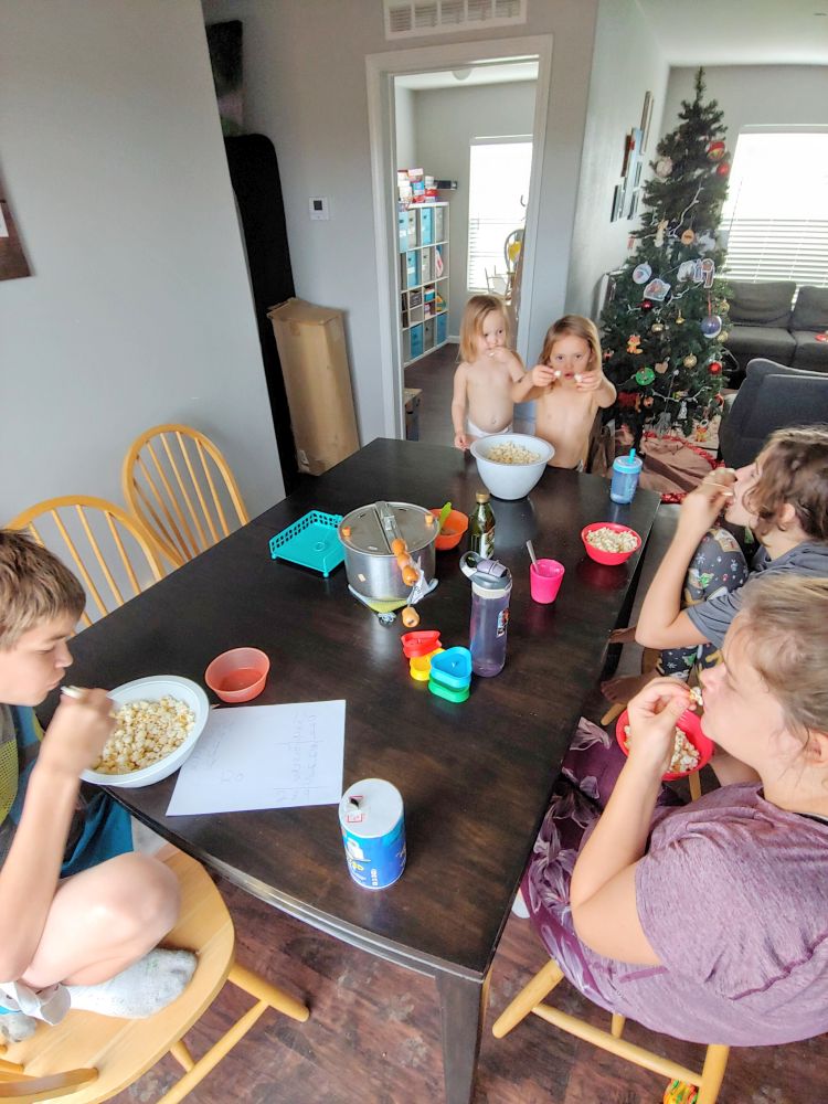 family eating popcorn at a table