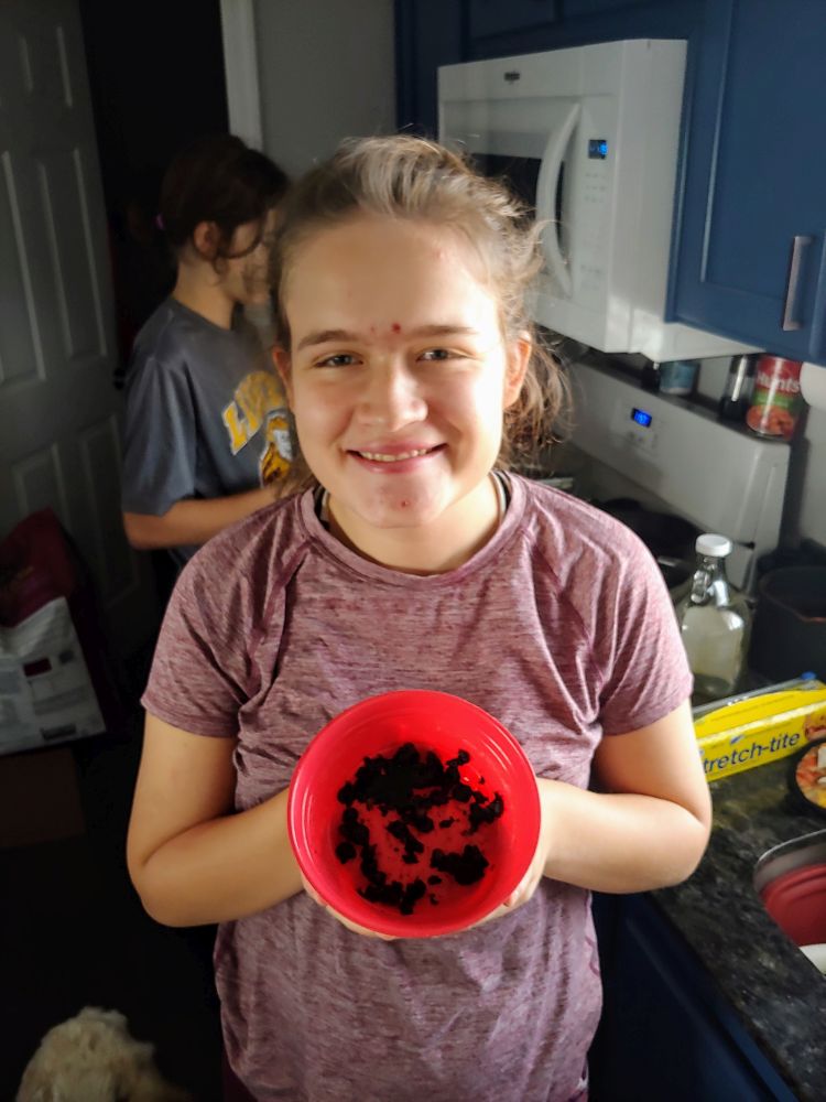 girl holding blackened popcorn